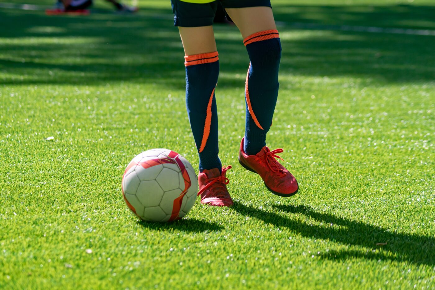 Football player with a ball on the pitch. Bottom view.